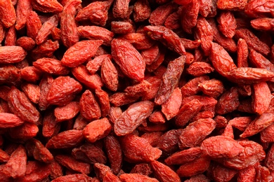 Photo of Many dried goji berries as background, closeup. Healthy superfood