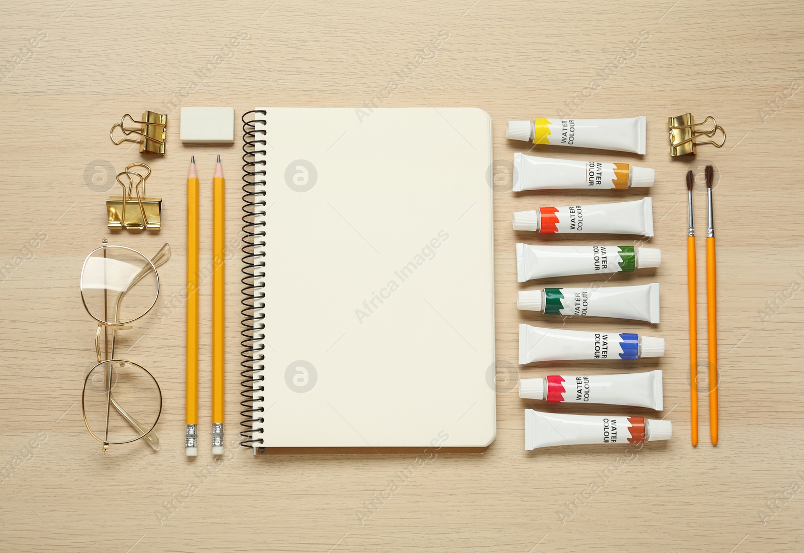 Photo of Flat lay composition with blank sketchbook on wooden table. Space for text