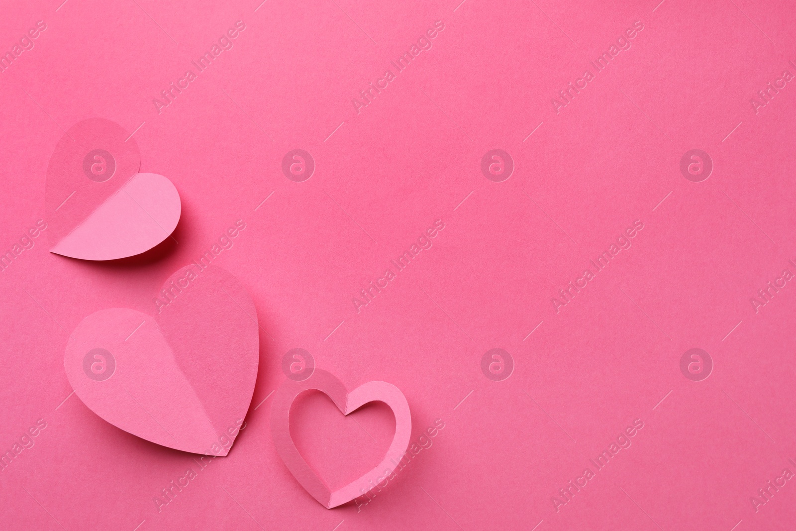 Photo of Paper hearts on pink background, flat lay. Space for text