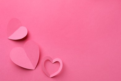 Photo of Paper hearts on pink background, flat lay. Space for text