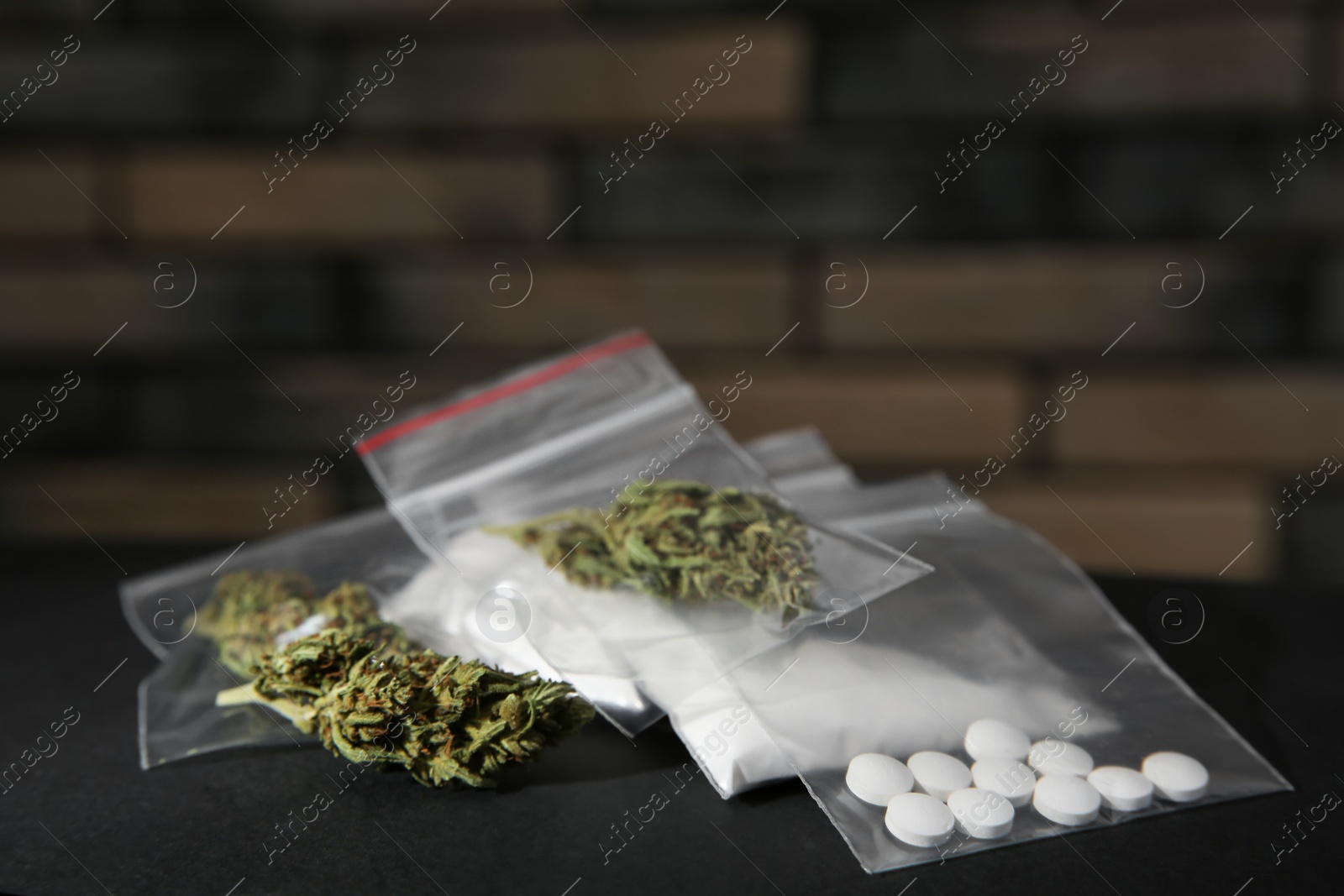 Photo of Cocaine, dried hemp and ecstasy on grey table. Space for text