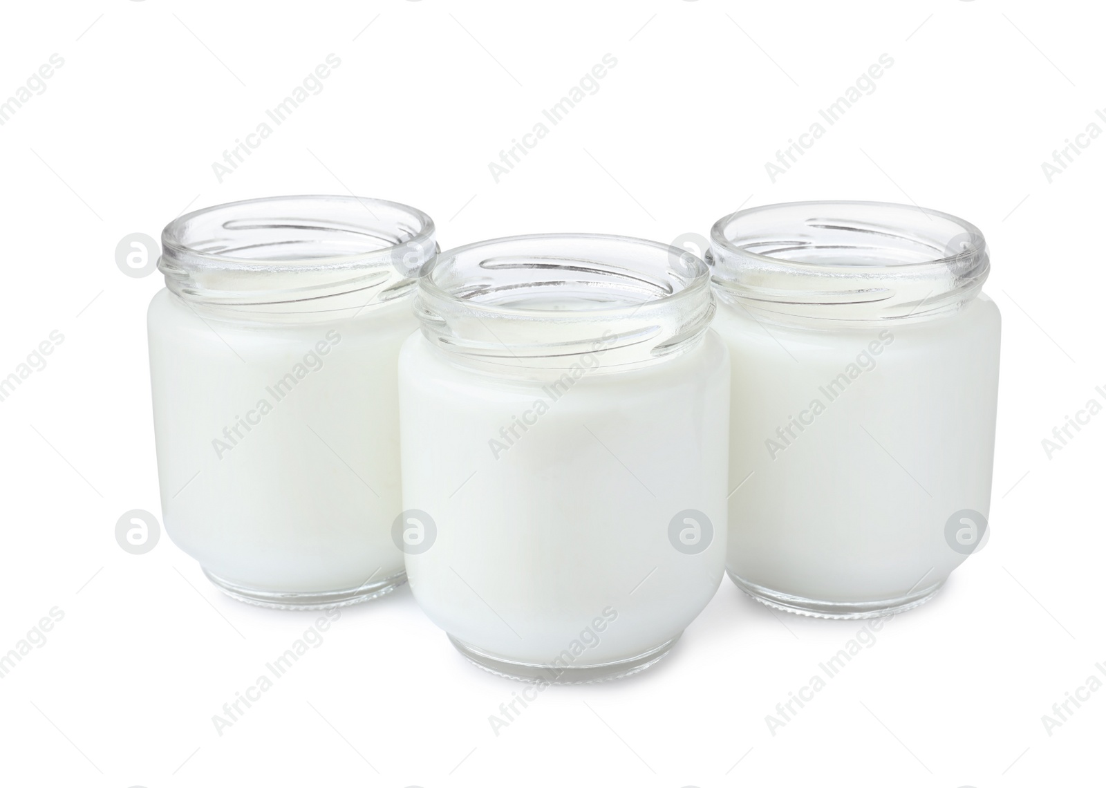 Photo of Glass jars with delicious homemade yogurt on white background