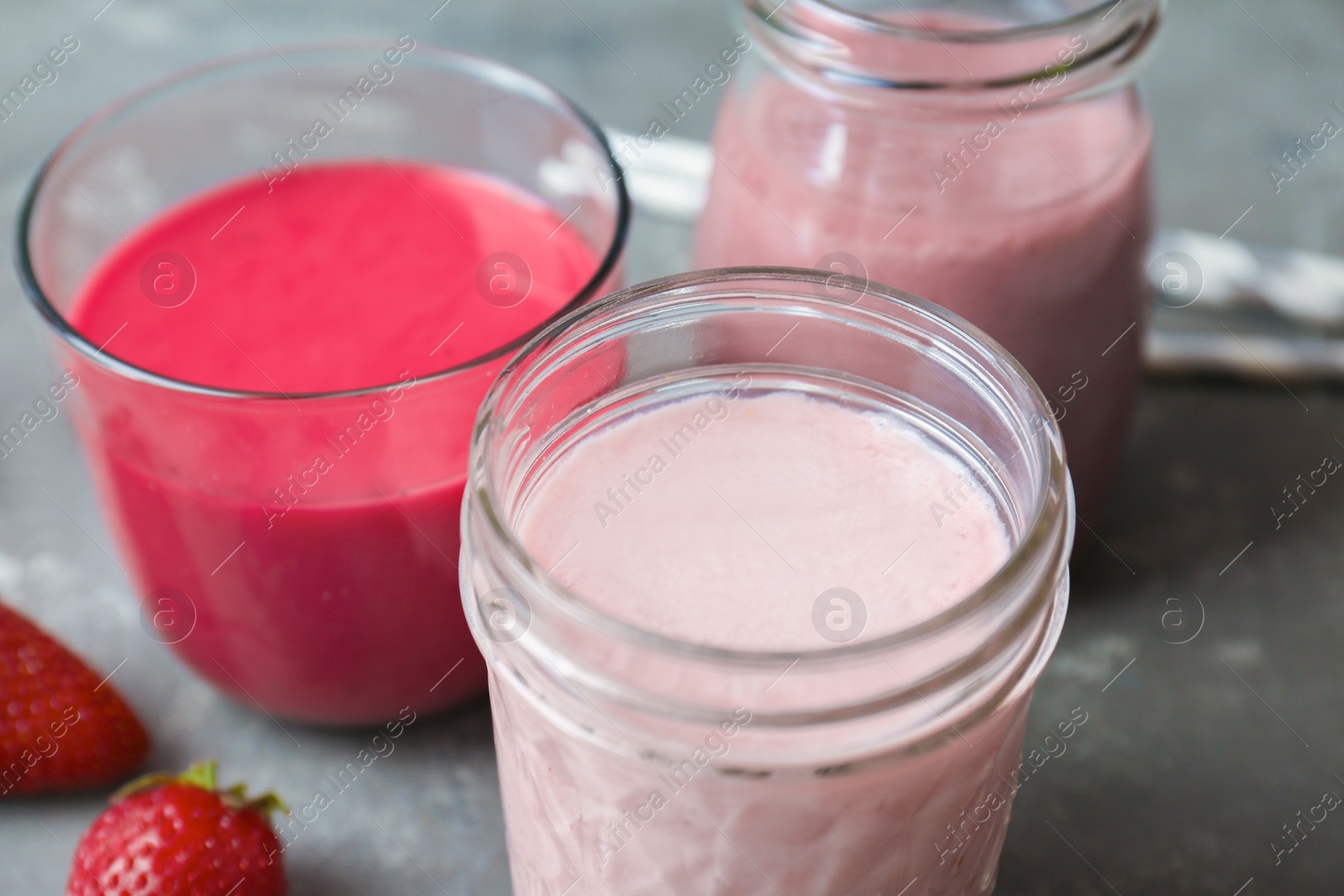 Photo of Glassware with healthy detox smoothies on table, closeup