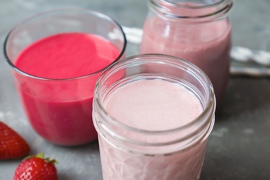 Photo of Glassware with healthy detox smoothies on table, closeup