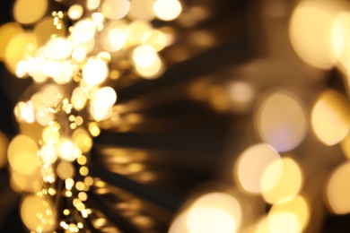 Photo of Golden blurred lights on black background. Bokeh effect