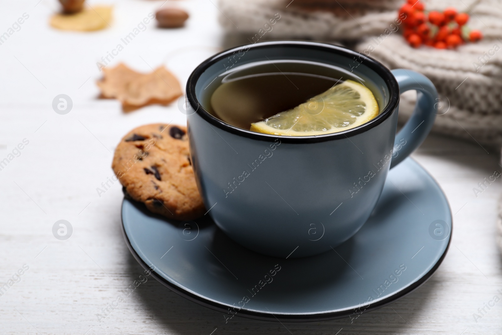 Photo of Cup with hot drink on white wooden table. Cozy autumn