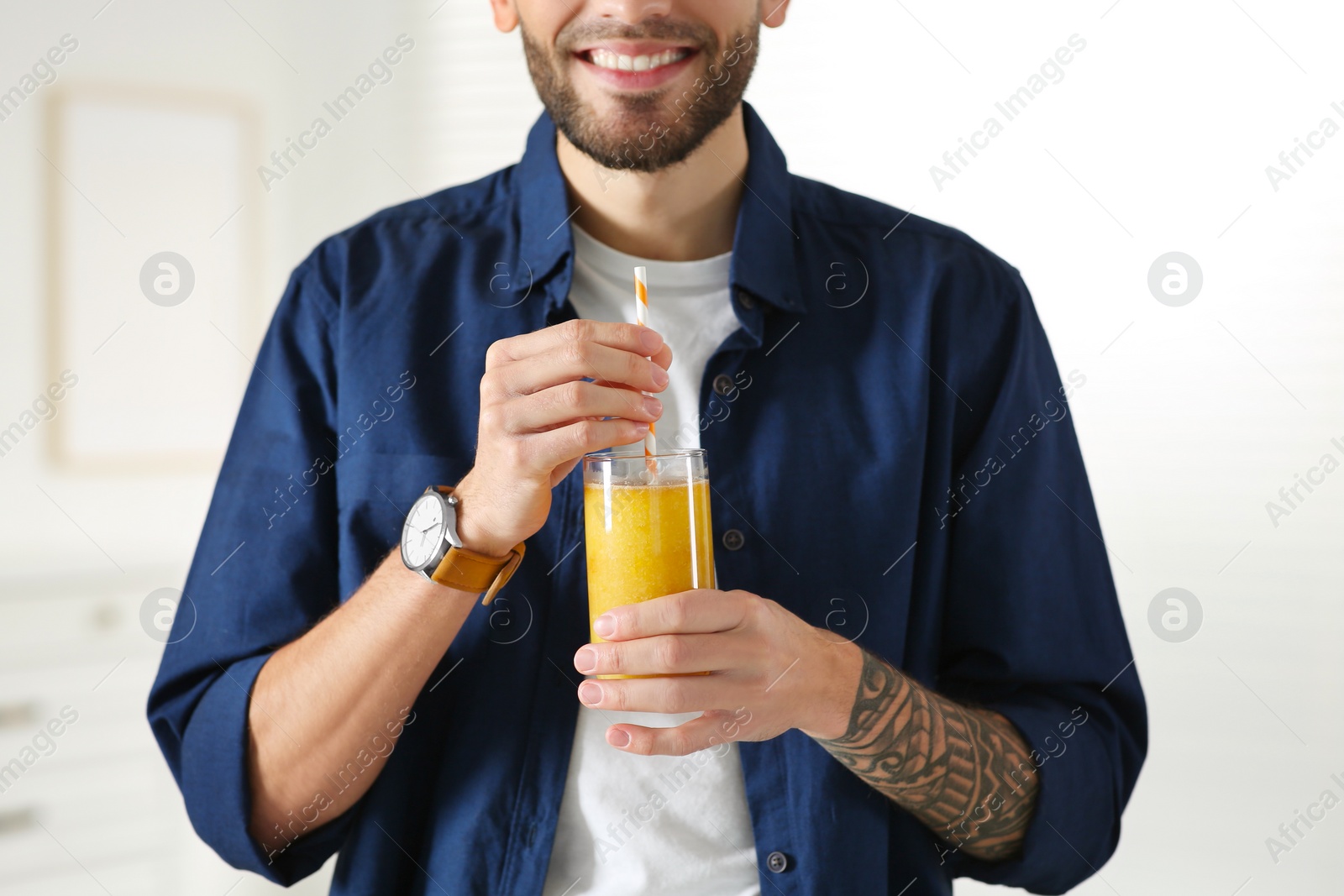 Photo of Man with delicious smoothie at home, closeup