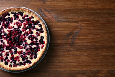 Delicious currant pie on wooden table, top view. Space for text