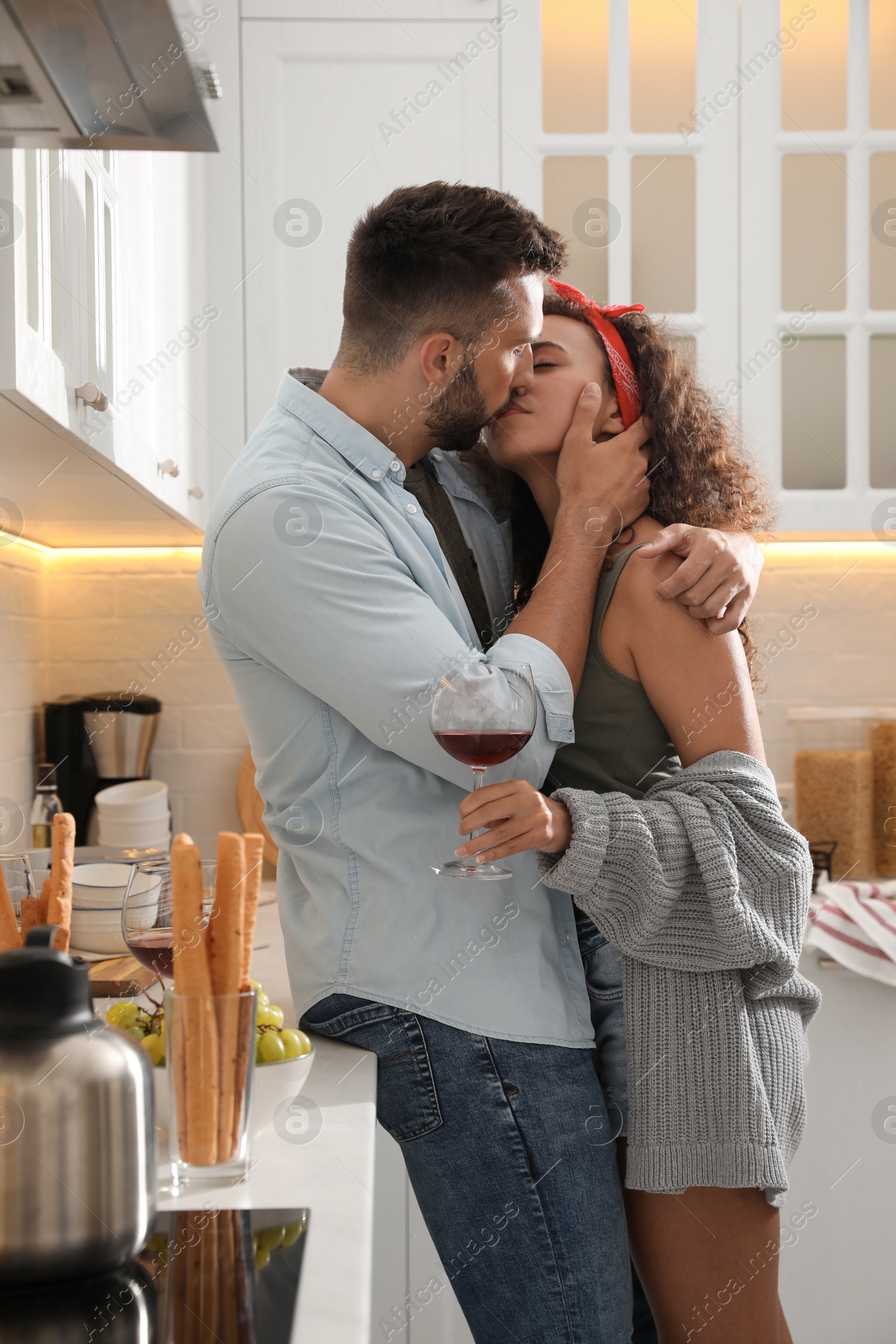 Photo of Lovely couple enjoying time together during romantic dinner in kitchen