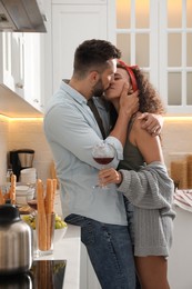 Photo of Lovely couple enjoying time together during romantic dinner in kitchen