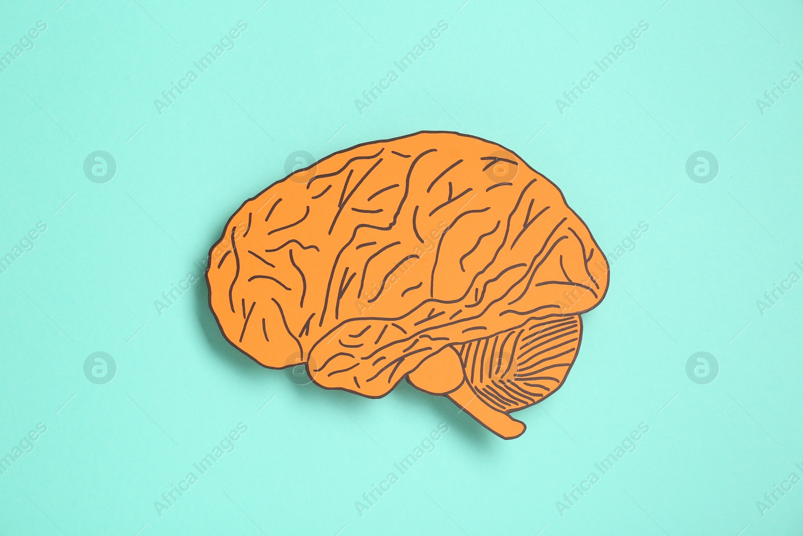 Photo of Paper cutout of human brain on light blue background, top view