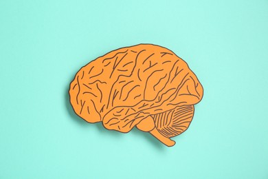 Paper cutout of human brain on light blue background, top view