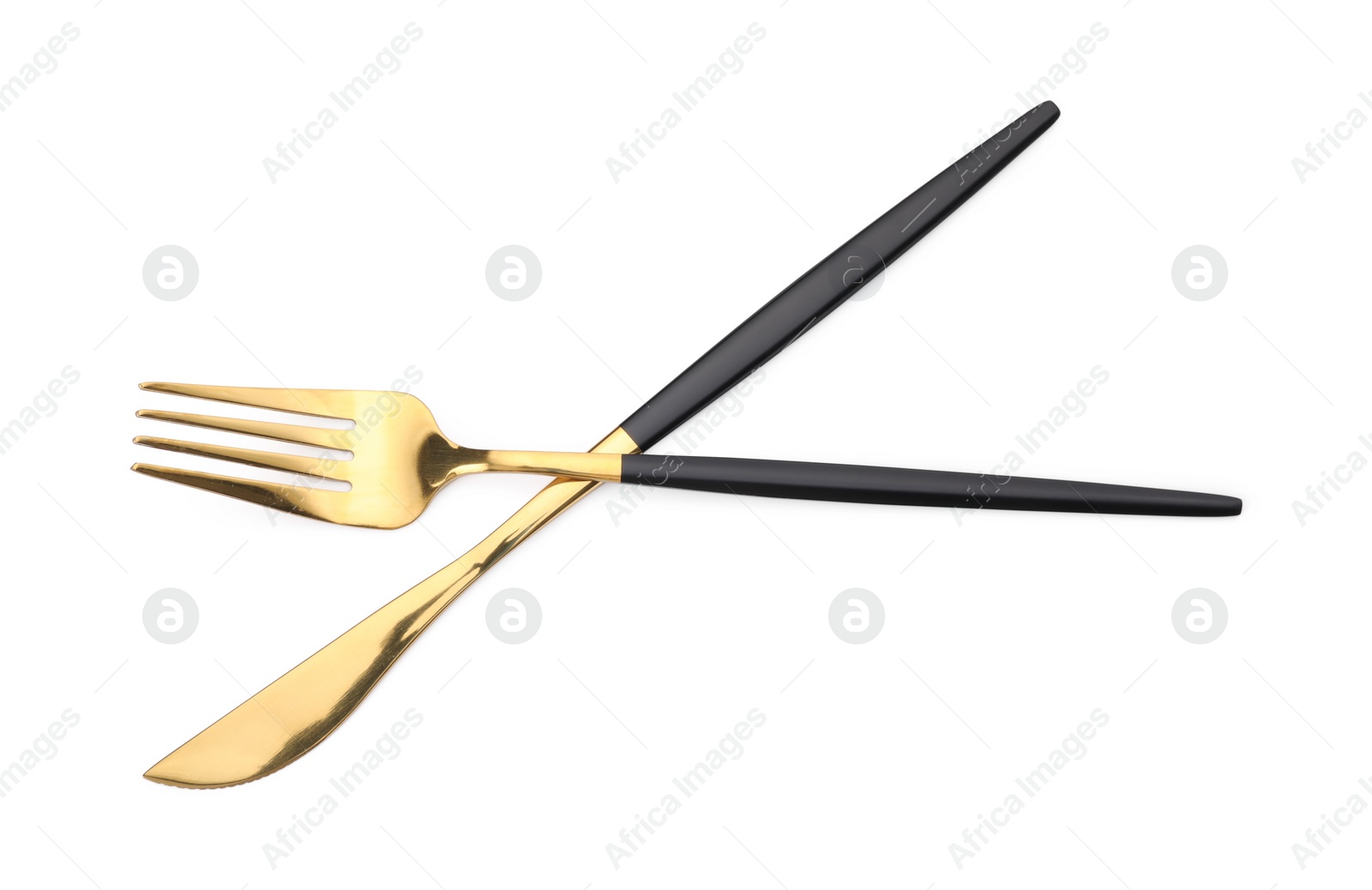 Photo of Shiny golden fork and knife isolated on white. Luxury cutlery