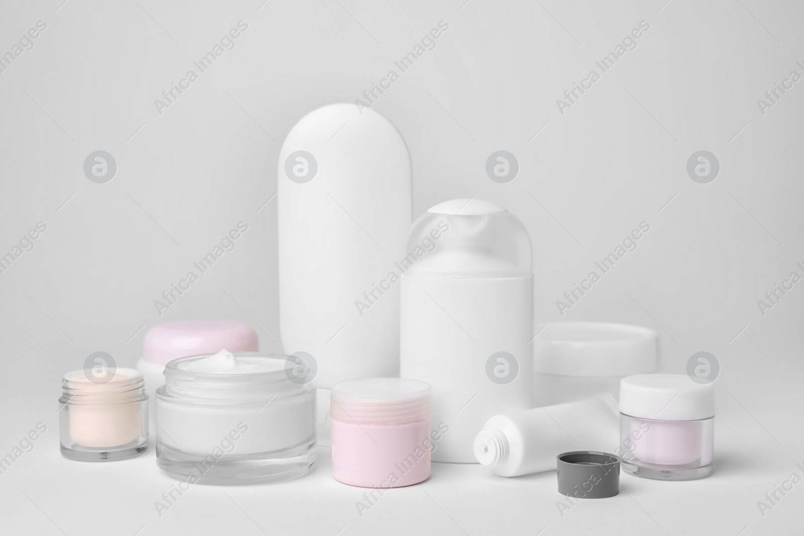 Photo of Composition with cosmetic products on light background