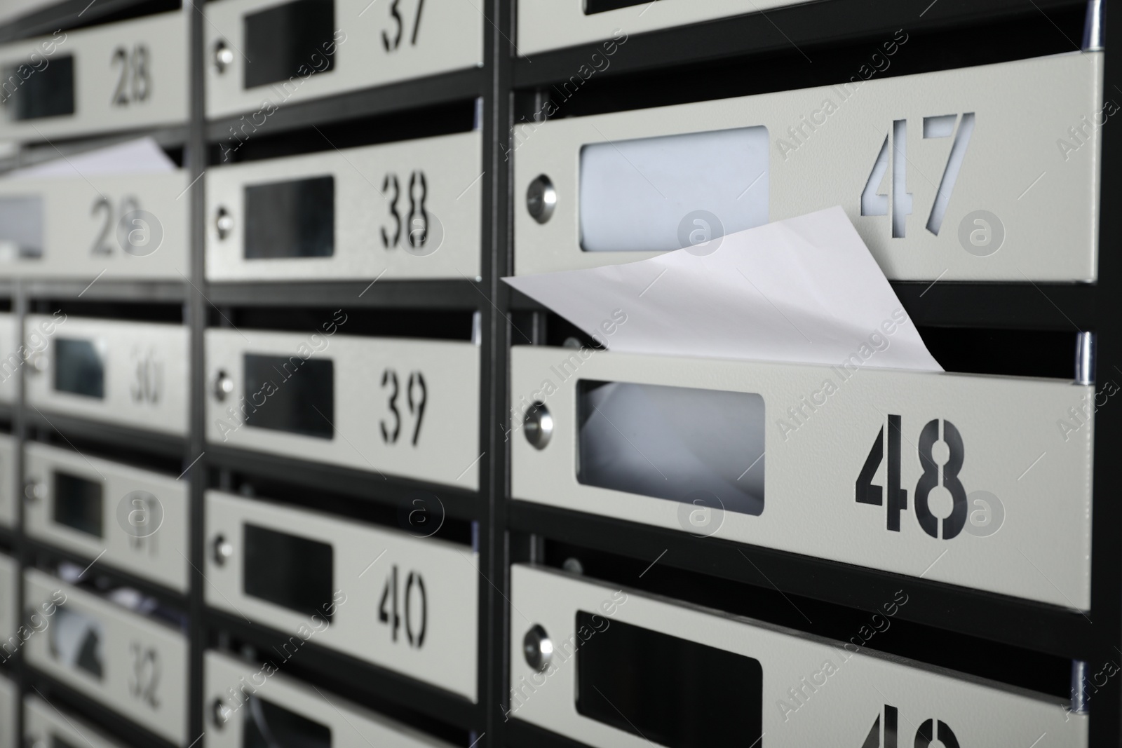 Photo of New mailboxes with keyholes, numbers and receipts, closeup