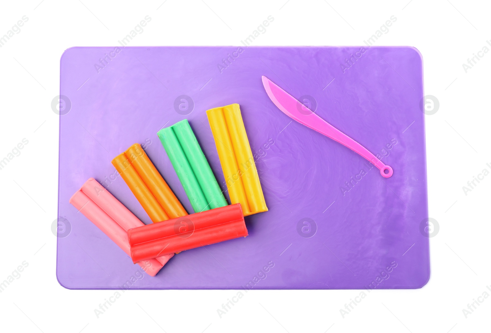 Photo of Many different colorful plasticine pieces and sculpting knife on white background, top view