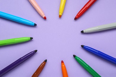 Photo of Different colorful markers on light background, flat lay. Space for text