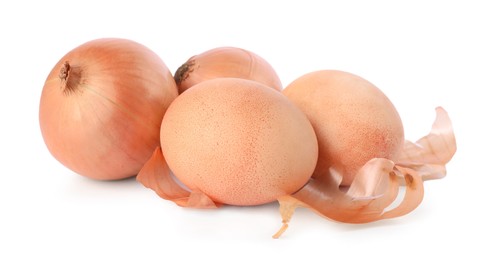 Photo of Easter eggs painted with natural dye and onions on white background