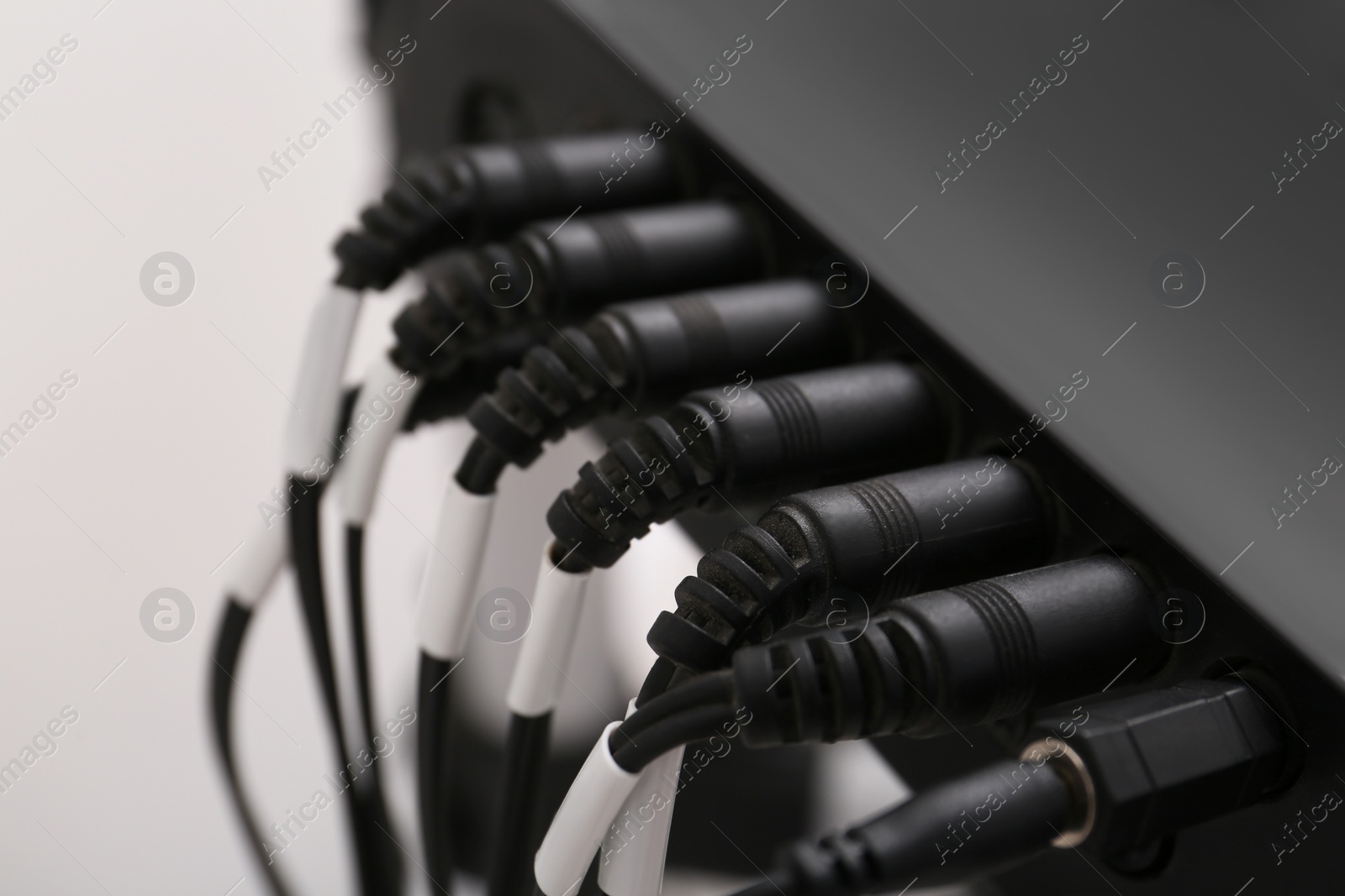 Photo of Modern electronic drum module with cables, closeup. Musical instrument