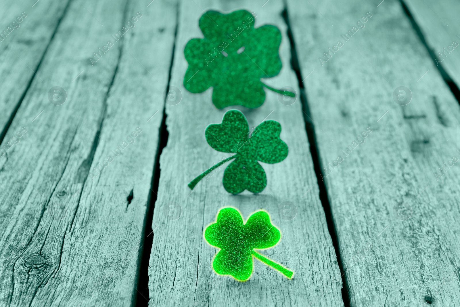 Image of St. Patrick's day. Decorative clover leaves on wooden background