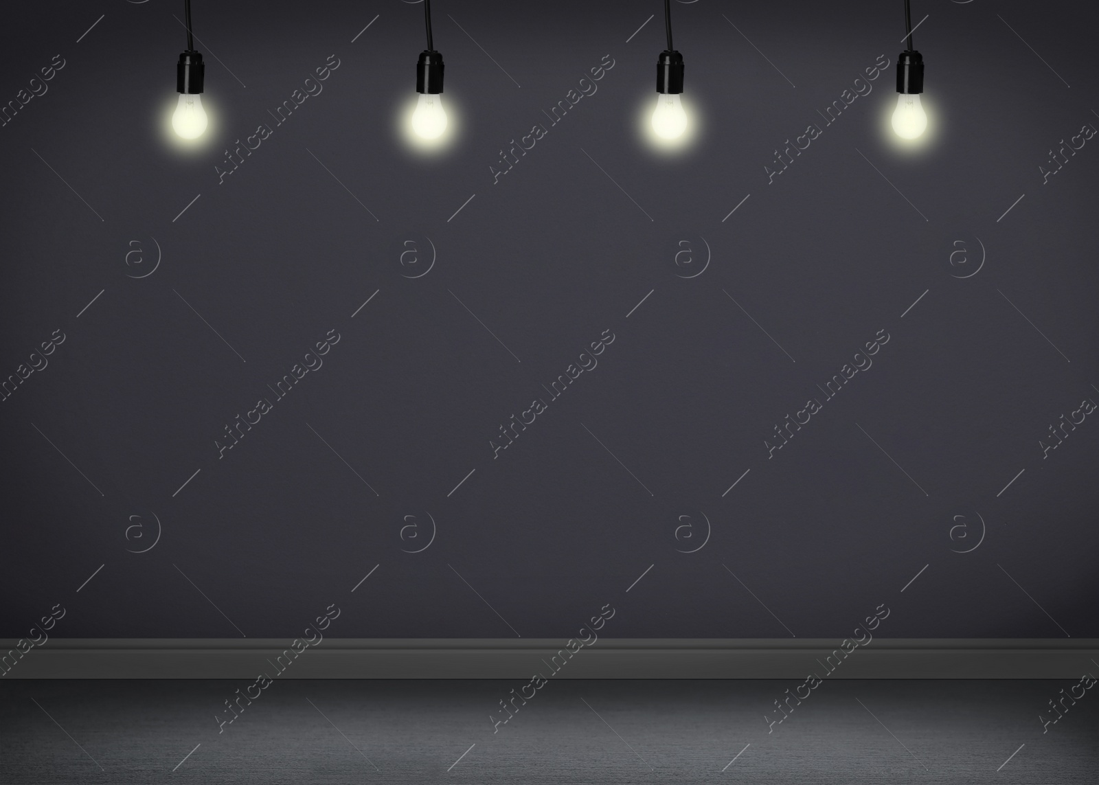 Image of Glowing light bulbs in room with grey wall and room