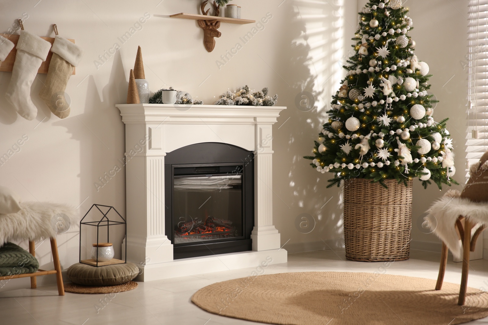 Photo of Beautiful living room interior with decorated Christmas tree and modern fireplace