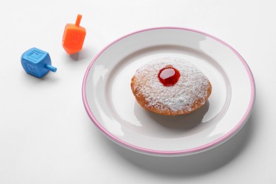 Photo of Hanukkah donut and dreidels on white background