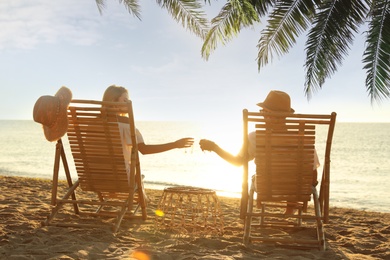 Image of Couple enjoying their summer vacation on sandy beach 