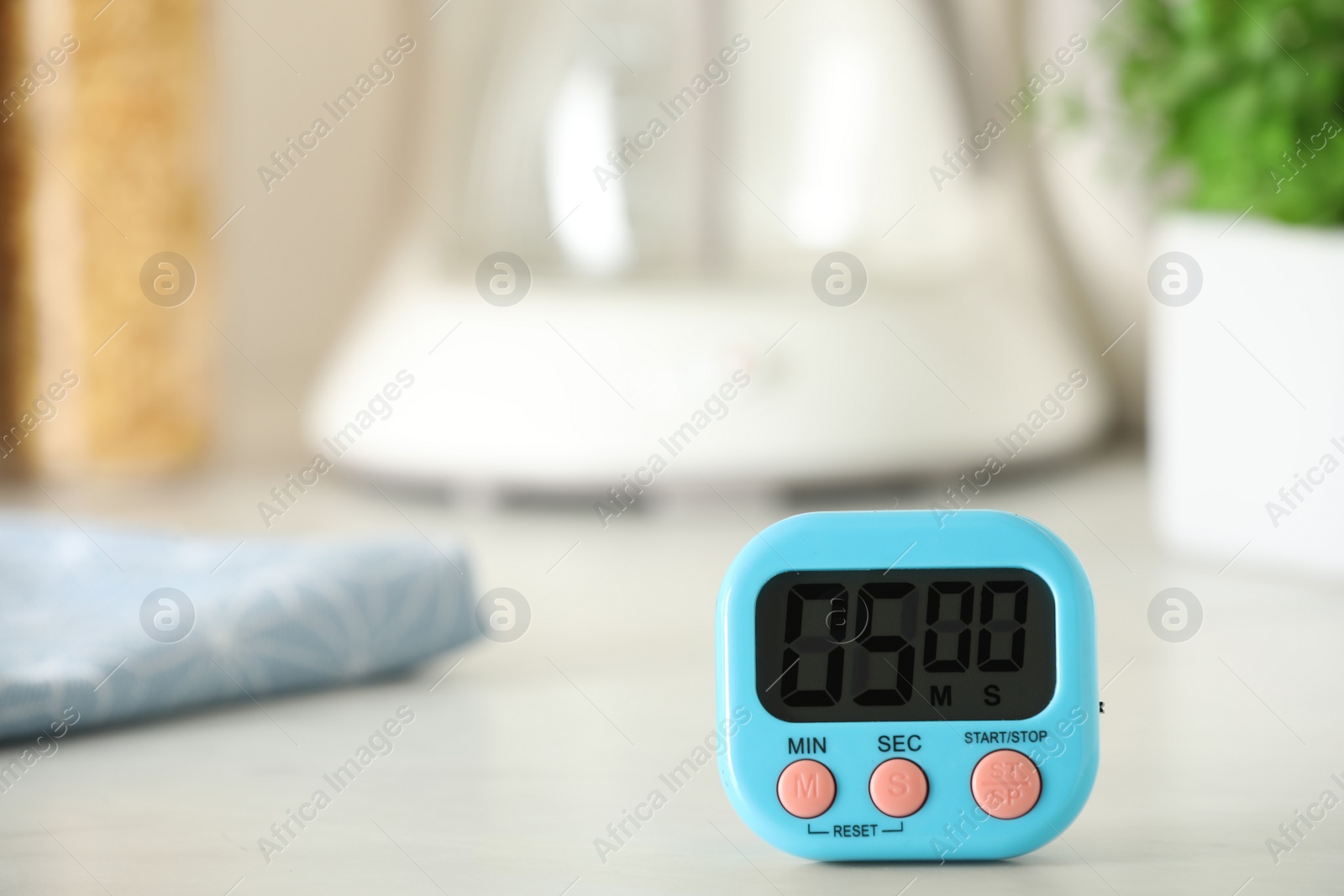 Photo of Digital kitchen timer on white table indoors. Space for text