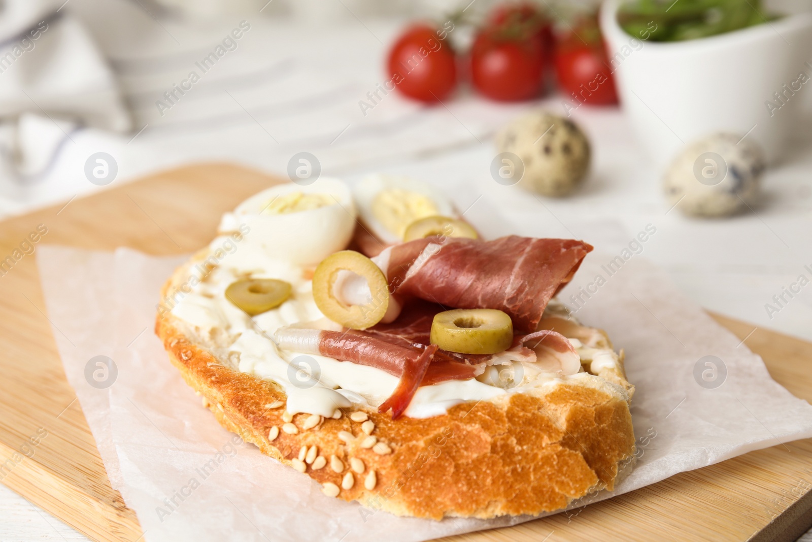 Photo of Cutting board with delicious bruschetta on table, closeup view