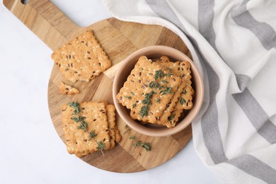 Photo of Cereal crackers with flax, sesame seeds and thyme in bowl on white table, top view