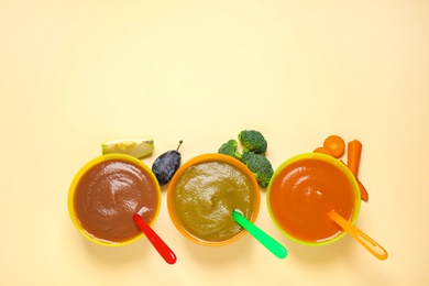 Photo of Healthy baby food and ingredients on yellow background, flat lay. Space for text