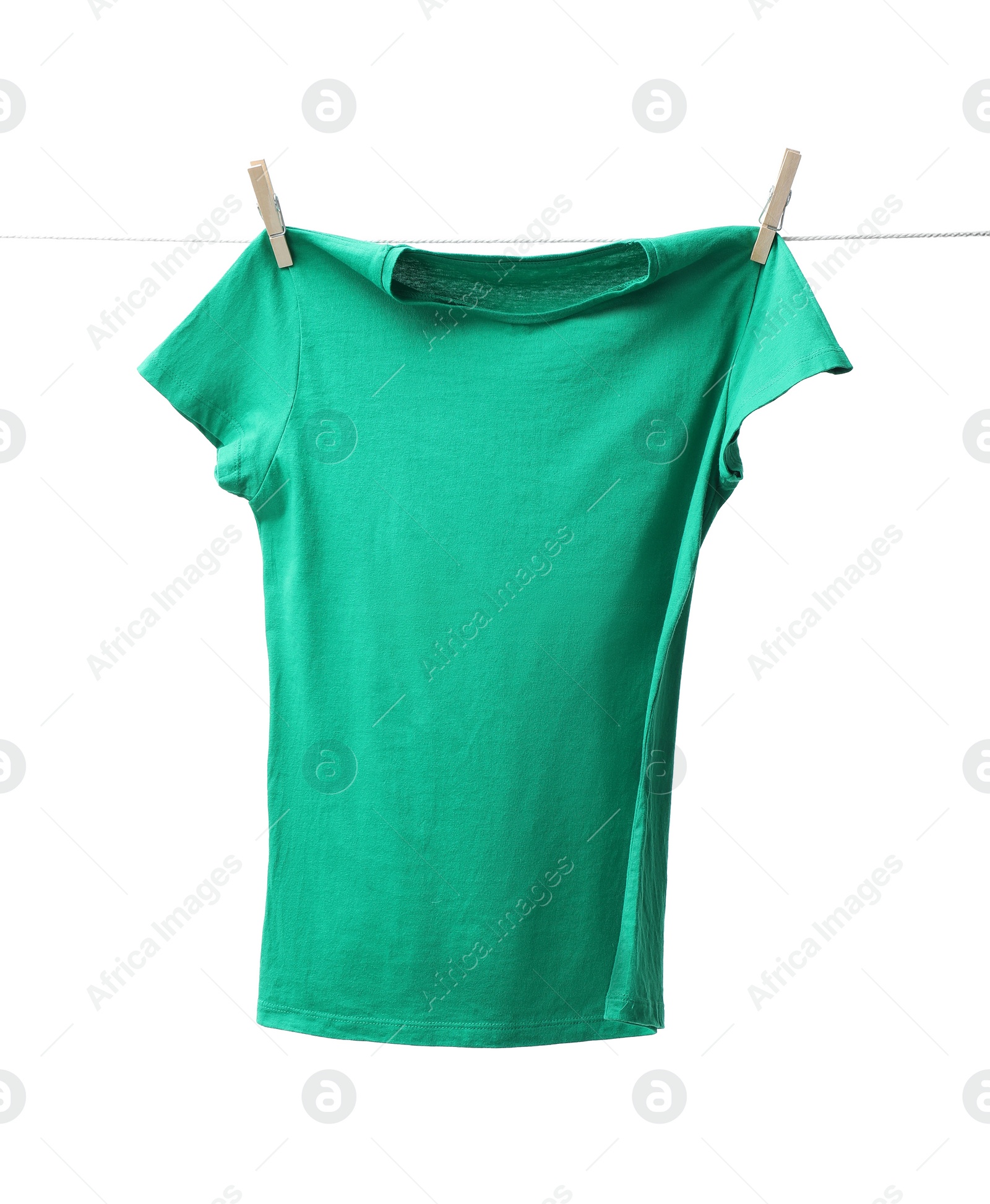 Photo of One green t-shirt drying on washing line isolated on white