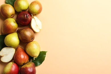 Ripe juicy pears on beige background, flat lay. Space for text