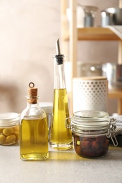 Photo of Bottles with fresh olive oil on table