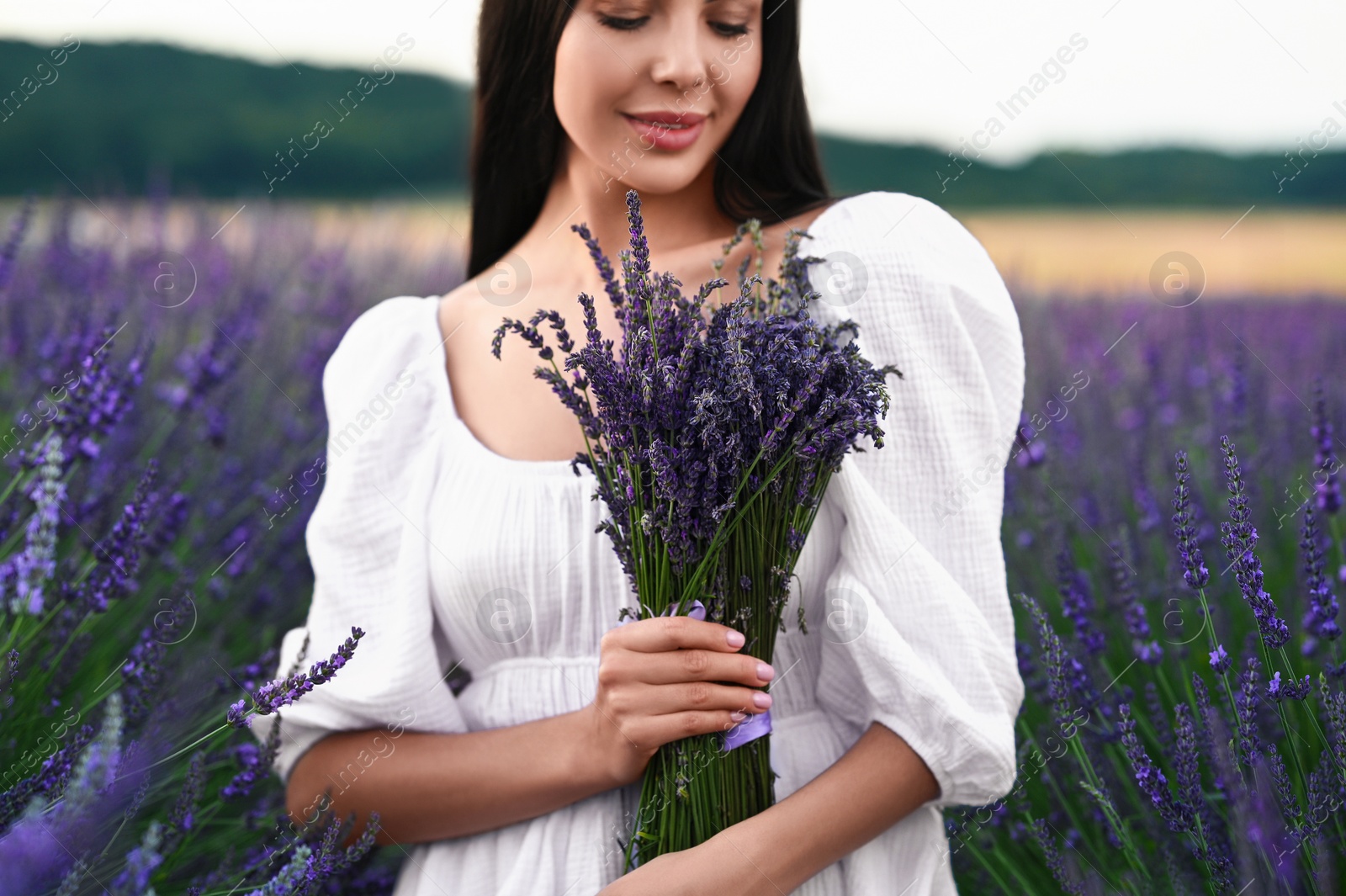 Photo of Woman with bouquet in lavender field, closeup