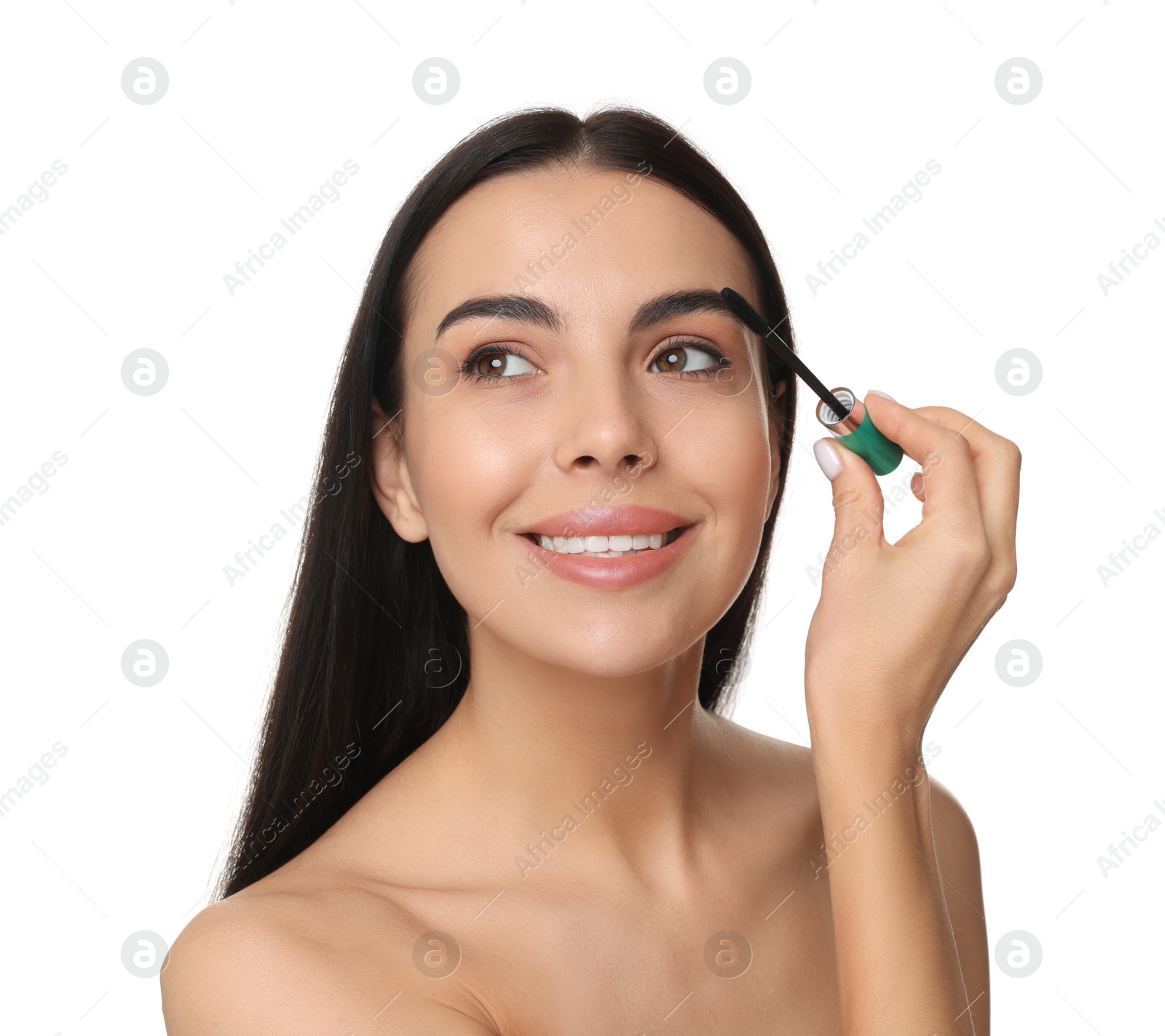 Photo of Beautiful young woman applying mascara on white background