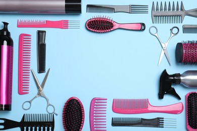 Photo of Frame of professional hairdresser scissors and other equipment on turquoise background, flat lay with space for text. Haircut tools