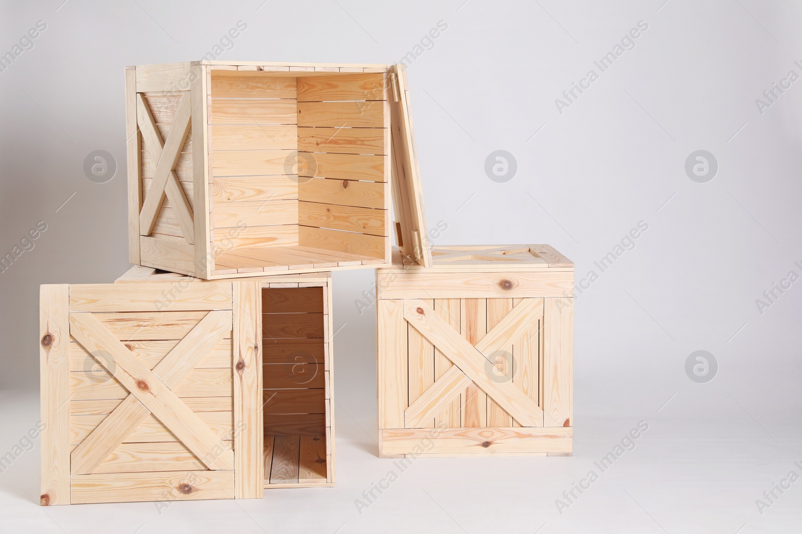 Photo of Wooden crates on grey background. Space for text