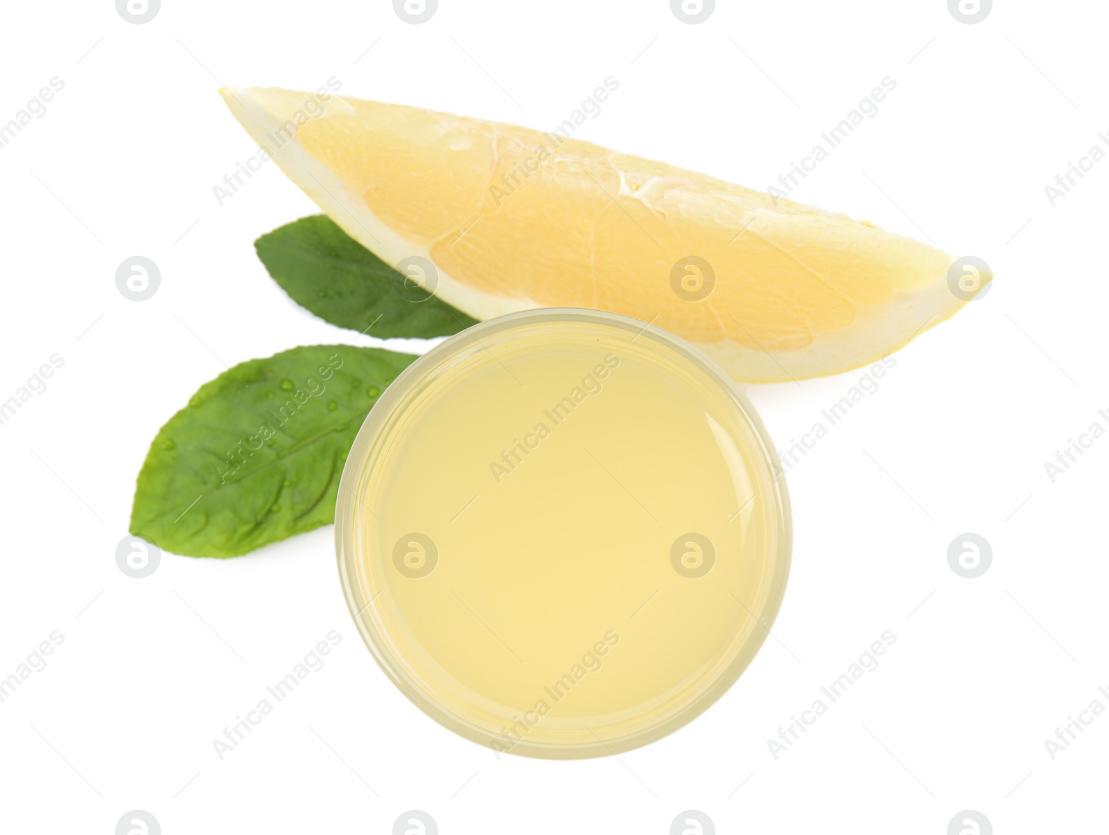 Photo of Glass of fresh pomelo juice, fruit and green leaves isolated on white, top view