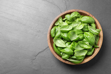 Photo of Fresh basil on grey table, top view. Space for text