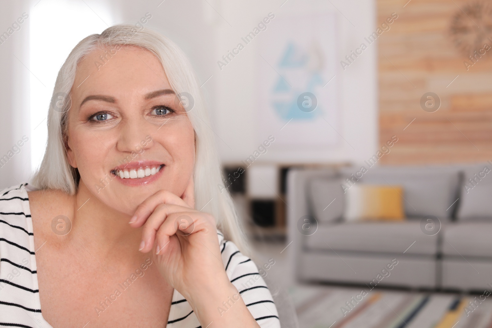 Photo of Portrait of mature woman in living room