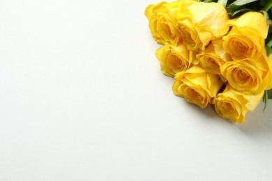Photo of Beautiful yellow roses on white background, above view. Space for text