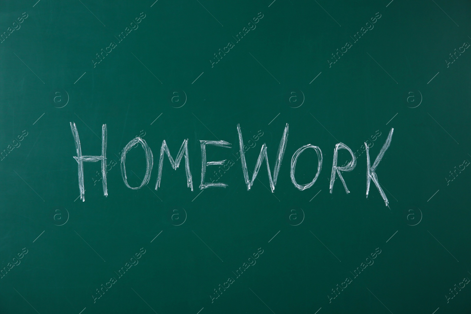 Photo of Word HOMEWORK written with chalk on green chalkboard