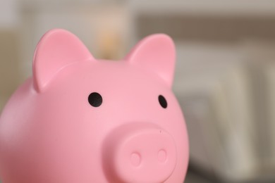 Photo of Pink piggy bank on blurred background, closeup