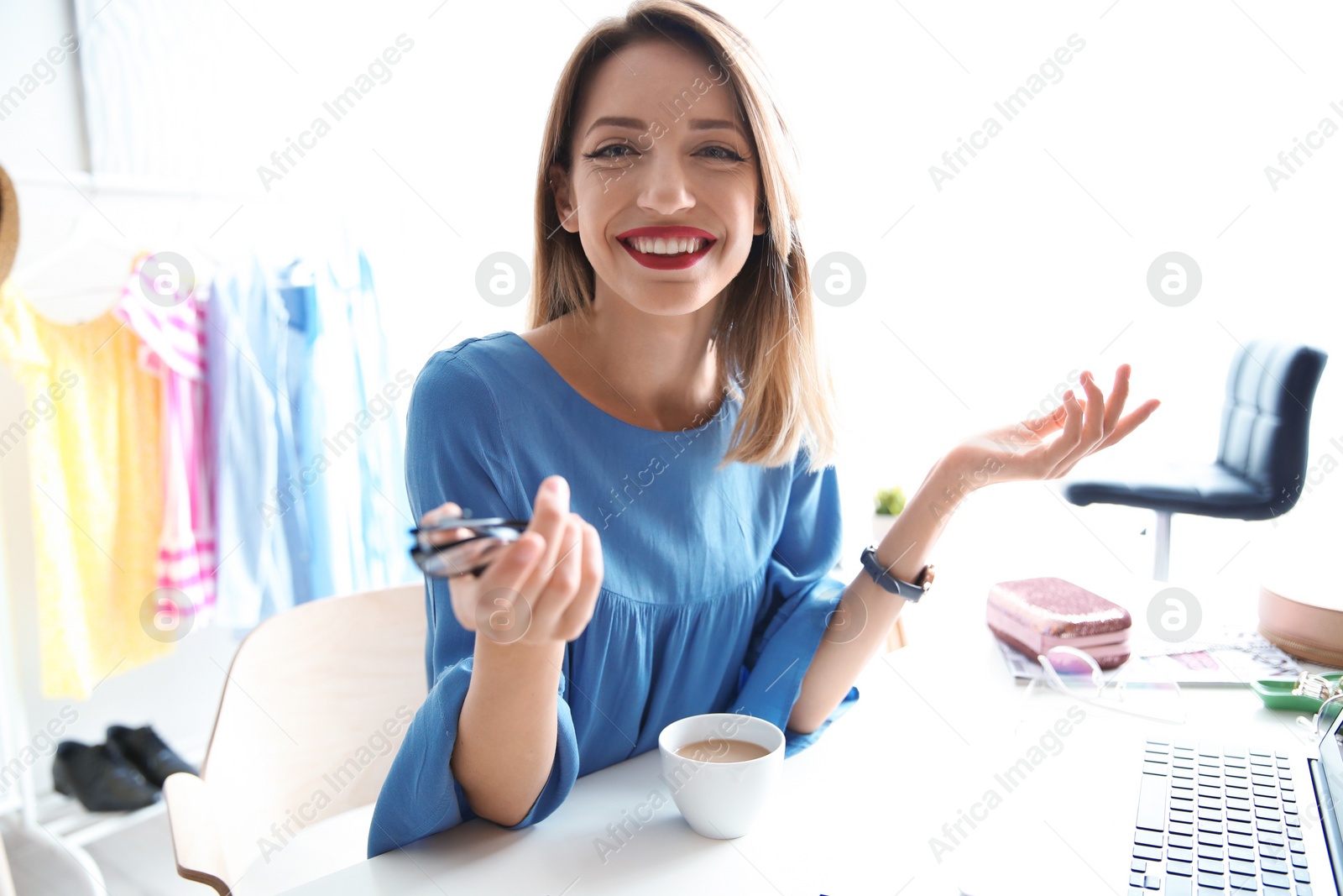 Photo of Portrait of female fashion blogger with laptop at home