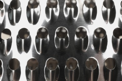 Photo of Modern metal grater as background, top view