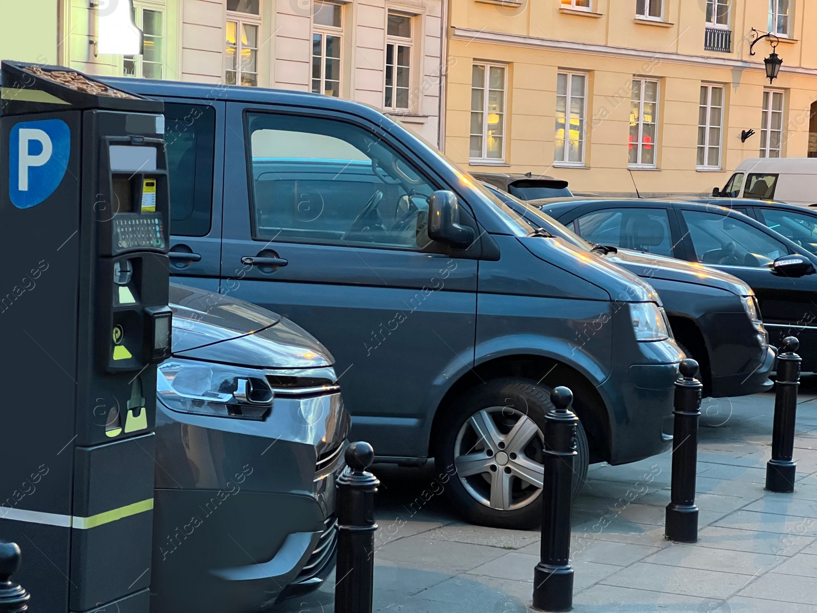 Photo of Paid parking with cars and meter on city street