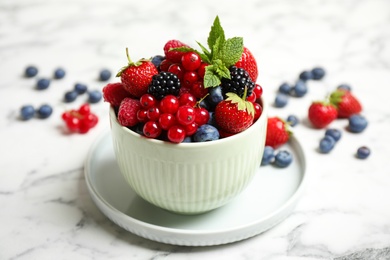 Photo of Mix of ripe berries on white marble table