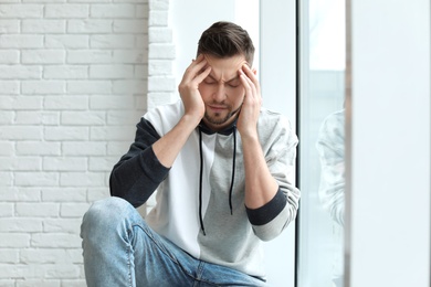 Man suffering from headache at home